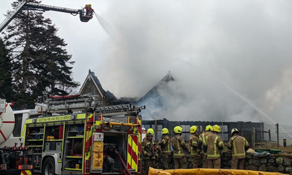 Fire crews spray water on the Braemar hotel from above.