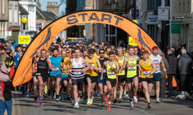 Max Abernethy, white vest, led from start to finish at Nairn to take the North 10k Road Race title.