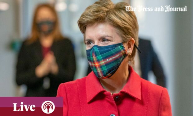 Grahpic of Nicola Sturgeon wearing a face mask.