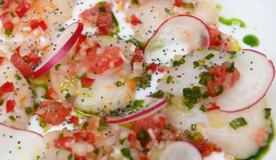 The scallops with radish and garnish on top