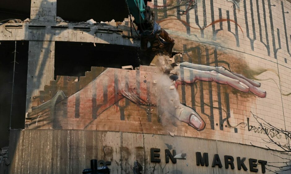 The mural getting demolished at Aberdeen Market