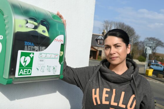 Michelle Birnie-Mackintosh with the defibrillator outside the New Moon Bar in Premnay. Picture by Paul Glendell