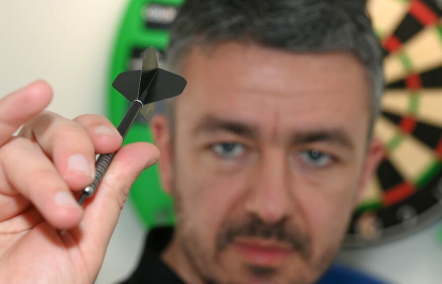 Shaun McDonald holding a dart