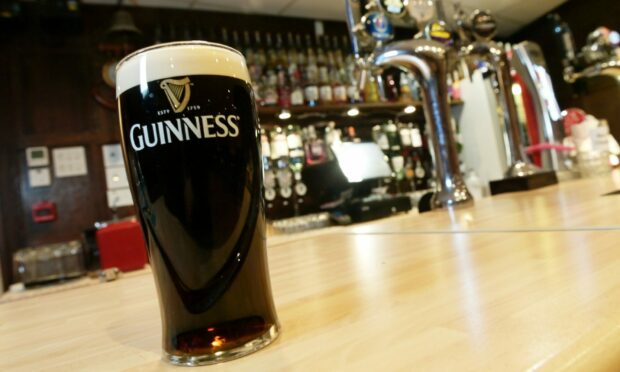 A pint of Guinness sat on the bar
