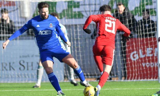 Cove Rangers defender Morgyn Neill challenges Peterhead's Grant Savoury