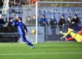 Mitch Megginson tucks away his second and Cove Rangers' third against Peterhead. Pictures by Duncan Brown