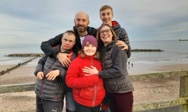Picture shows: Adam Brock with mum Samantha, dad Brian and siblings Caleb and Agnes.