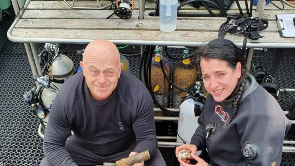 Ross Kemp with diver Emily Turton on a boat. 
