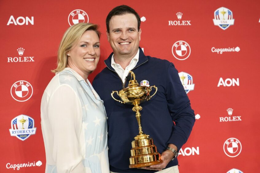 Zach Johnson, right, and his wife Kim pose with the Ryder Cup trophy