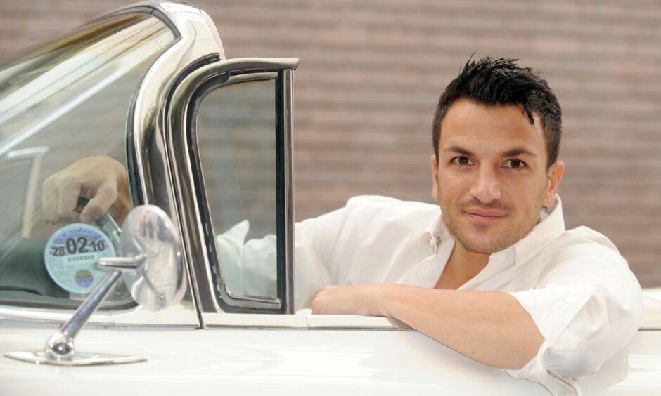 Peter Andre sitting in car.