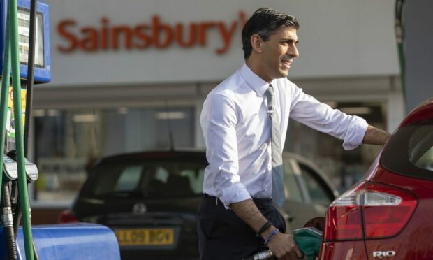 Chancellor Rishi Sunak filling his car with fuel..