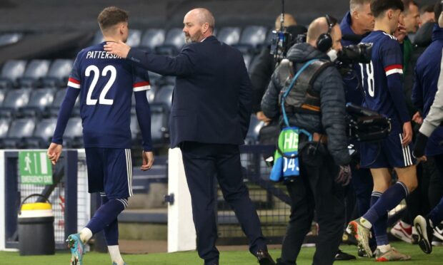 Scotland manager Steve Clarke greets Nathan Patterson during the friendly against Poland.