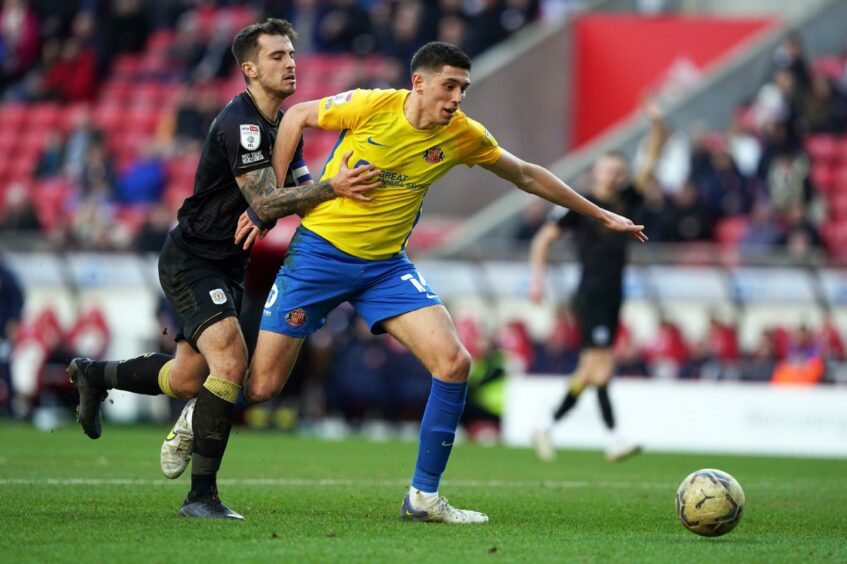 Sunderland's Ross Stewart and Crewe's Luke Offord battle for the ball