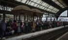People fleeing Ukraine wait at the platform inside Lviv railway station (Photo: AP Photo/Bernat Armangue)