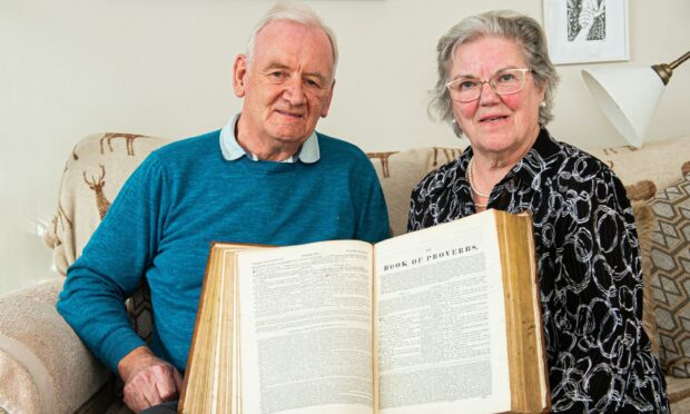 Bill with Mary Shewan, who's late husband Magnus had bought the bible many years ago. Picture by Wullie Marr / DCT Media
