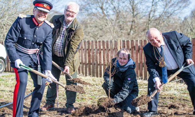 Lord Lieutenant Sandy Manson DL, VSA chief executive Kenneth Simpson, David Gettigan who is an adult trainee and Lord Provost Barney Crockett planting the first tree.