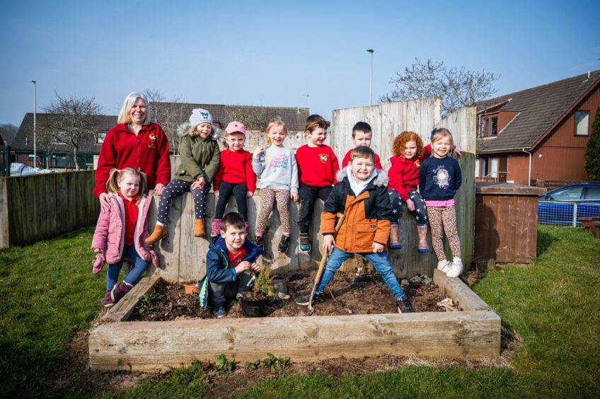 Kids in a raised garden outside the Kemnay nursery