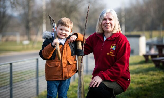 Carter Walters, who came up with the idea, with Michelle Morrison beside the apple tree they have planted. Picture by Wullie Marr
