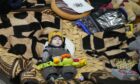 A boy holds a toy as he rests in a center for Ukrainian refugees in Warsaw. AP Photo/Czarek Sokolowski