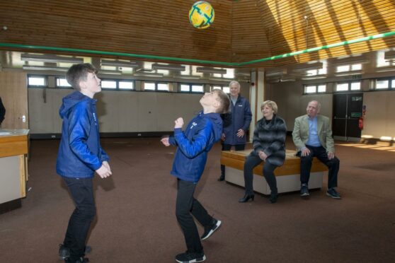 Dyce Library is going to be transformed into a sports club. Zack Mournian  and Ryan Nicol, from Dyce Boys Club FC, show off their moves to council leader Jenny Laing, football coach Len Nicol and SportAberdeen's Tony Dawson. Supplied by Aberdeen City Council