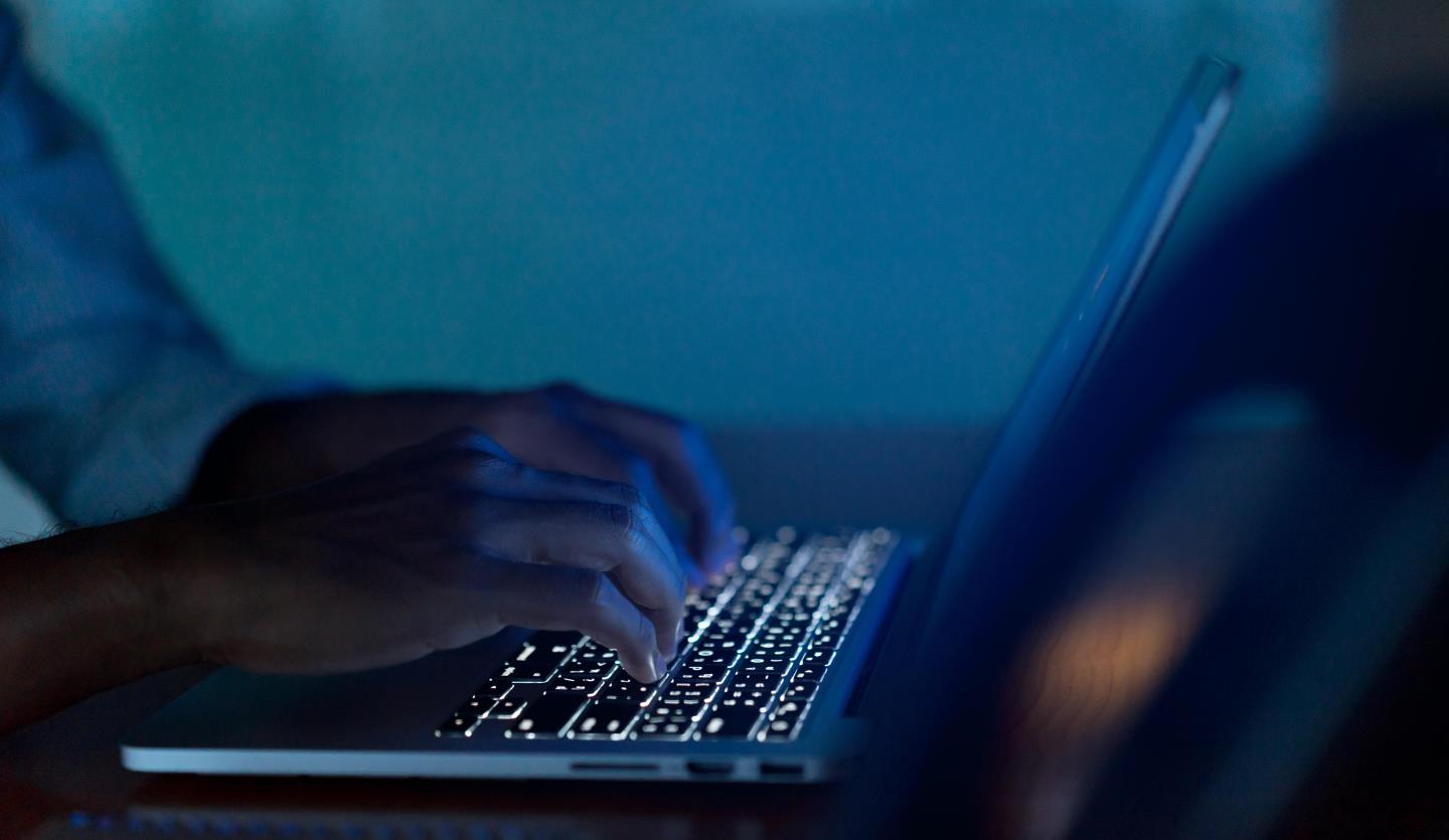 Close-up of man typing on computer keyboard