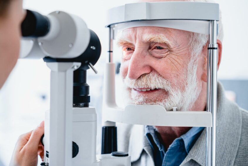 Close up photo of smiling senior male patient during sight examination