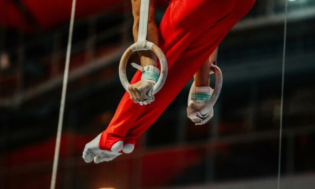 Stock image of gymnast on rings.