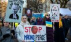 People take part in a protest against the Russian invasion of Ukraine in front of the Russian embassy in Vilnius, Lithuania (Photo: Uncredited/AP/Shutterstock)