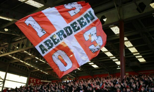 Aberdeen supporters at Pittodrie. Image: Shutterstcok