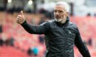 Aberdeen manager Jim Goodwin gives the thumbs up to fans.