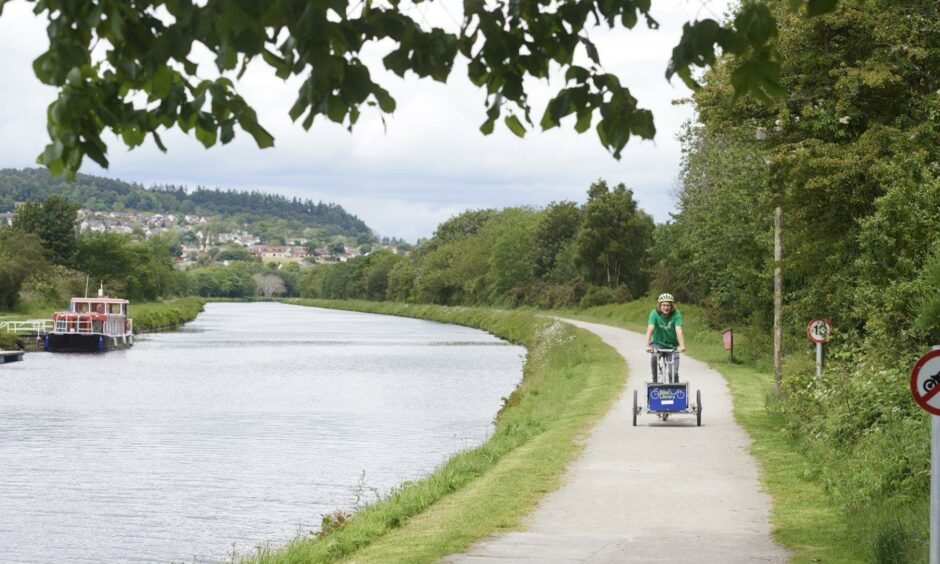 A cyclist enjoying a ride along the banks of the Caledonian Canal in Inverness
