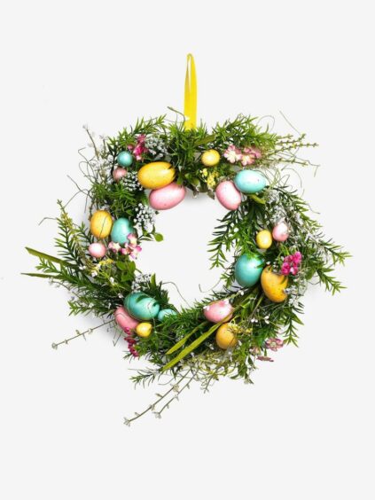 Green wreath with blue, pink and yellow eggs.