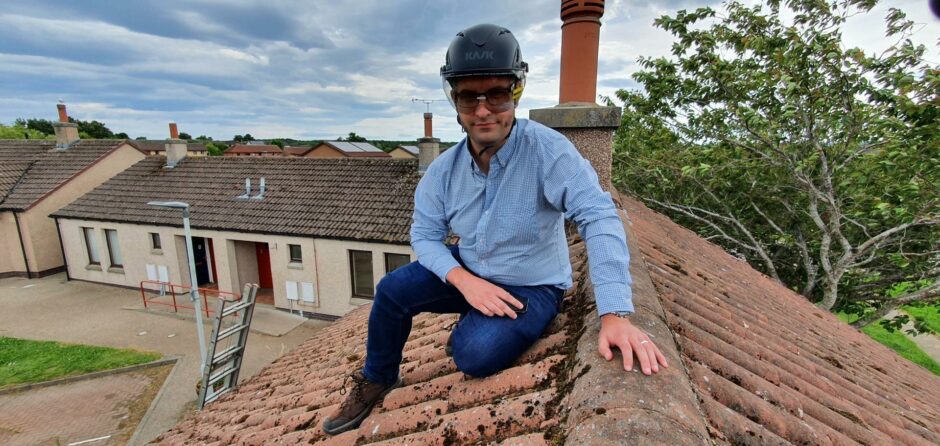 David Mackay on top of a roof in Elgin