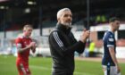 Aberdeen manager Jim Goodwin applauds the large travelling support after the 2-2 draw at Dundee.