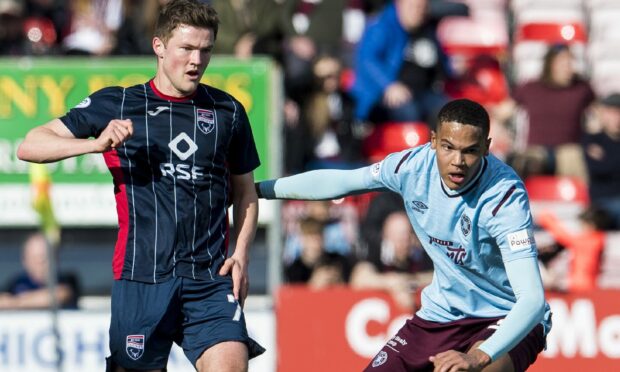 Ross County's Blair Spittal (left) in action against Hearts.
