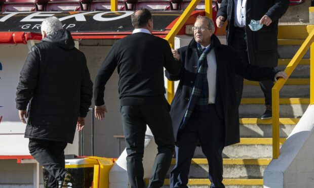 Malky Mackay greets Roy MacGregor at the full-time whistle at Pittodrie.