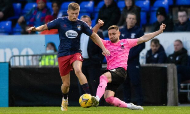 Kilmarnock's Fraser Murray is challenged by Caley Jags defender Danny Devine.