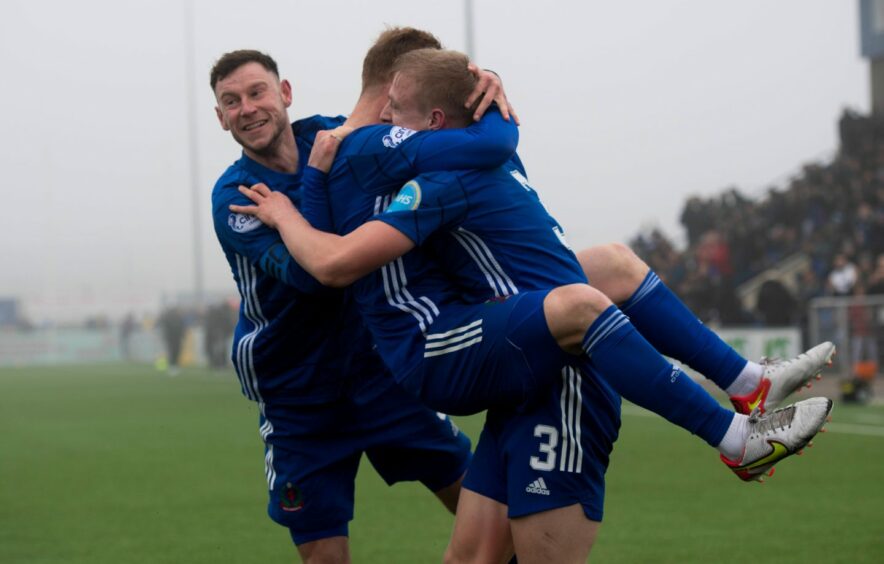 Harry Milne (3) is congratulated by Cove team-mates Mitch Megginson and Fraser Fyvie