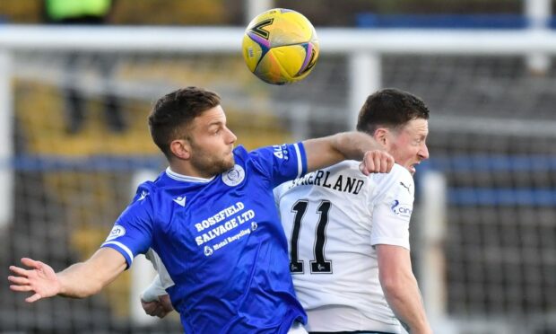 Queens' Alex Cooper (left) and Inverness striker Shane Sutherland challenge for the ball in the air.