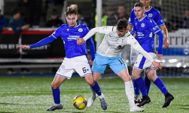 Aaron Doran gets stuck in against Queen of the South's Harry Cochrane.