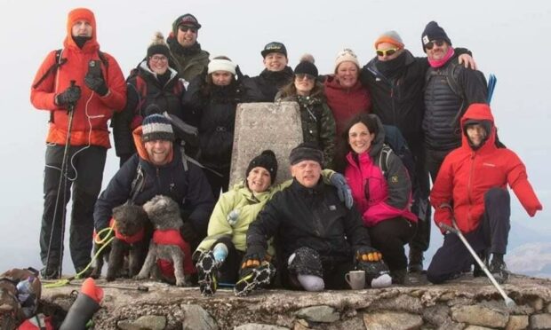 Paul Ellis and a team of helpers helped him get to the top of Ben Nevis. Picture by Lucy MacAlpine.