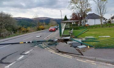 Fire crew remove a 'live' lamp-post from A82. Picture by Eric Taylor