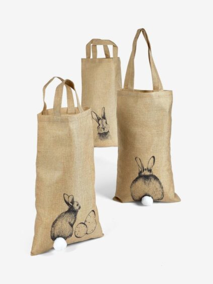 Light brown sacks with bunny prints and pompons as the bunnies' tails.
