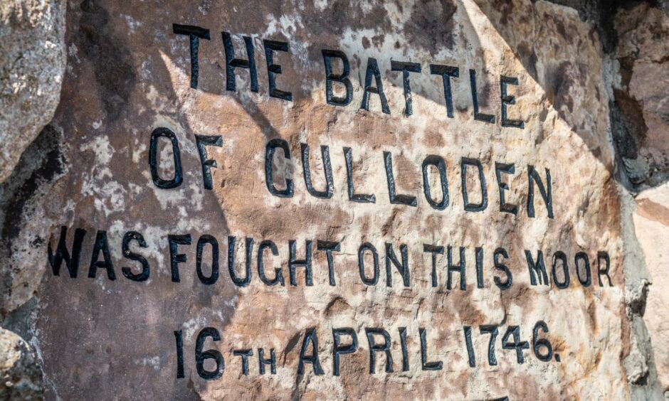 Memorial monument that reads "The battle of Culloden was fought on this moor 16th April 1746".
