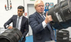 Rishi Sunak (left) and Boris Johnson during a visit to Fourpure Brewery in London. Supplied by Dan Kitwood/AP