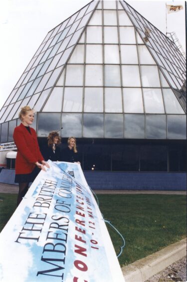 Three women hold a banner that reads "The British Chambers of Commerce"