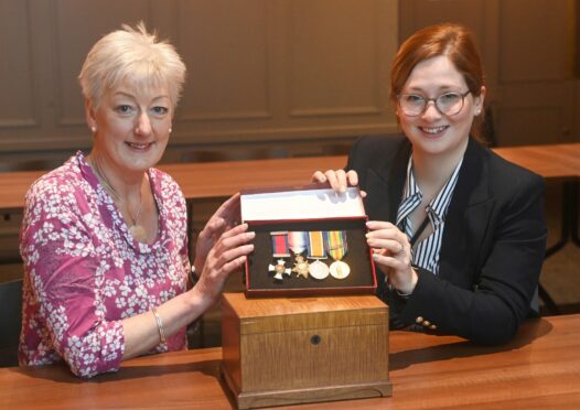 Gill Brisley, left and curator Ruth Cox with the donated medals. Picture by Chris Sumner