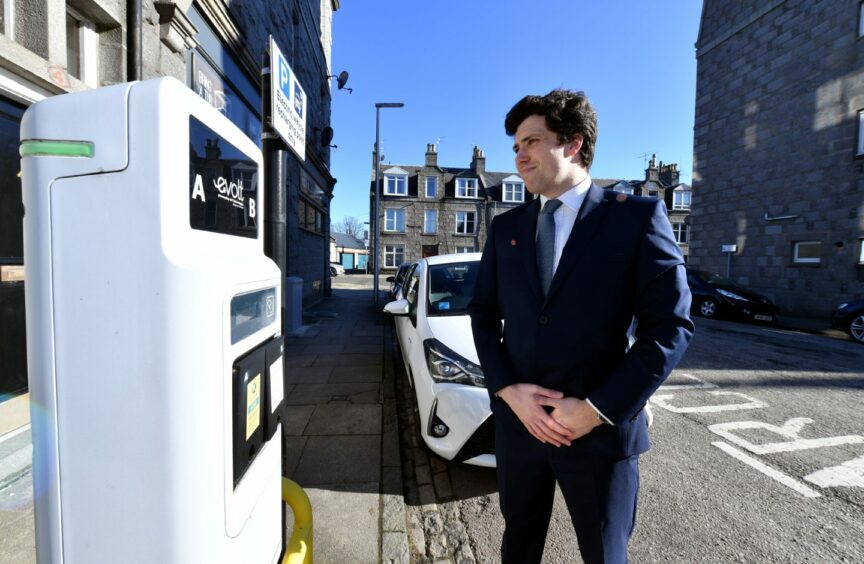 Ryan Houghton with an EV charger in Aberdeen. Picture by DCT Media.
