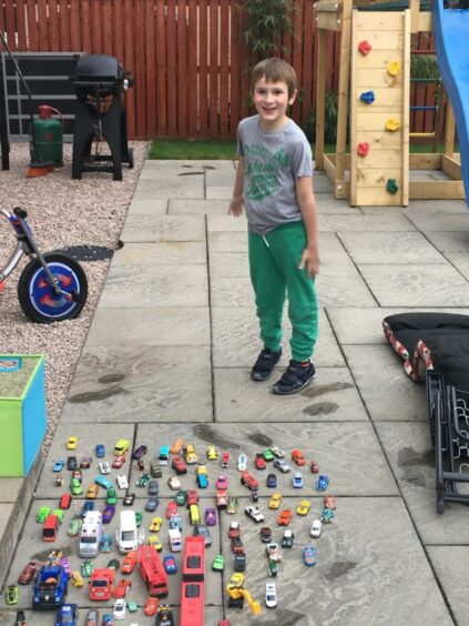 Cameron shows off his toy car collection