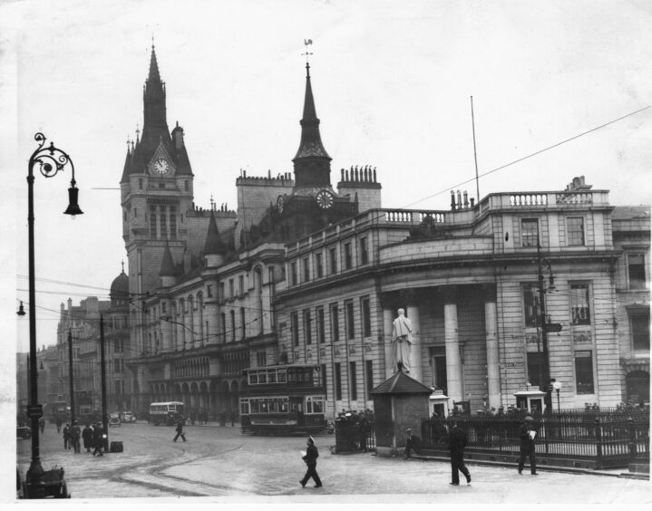 Trams passing Aberdeen's Castlegate in 1936. The Greens want to "properly look" at the case for their return.